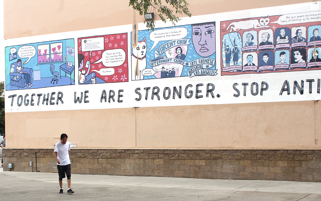 A man walks outside the Garvey Park Gym in Rosemead, California, in September 2022. Artist MariNaomi created the mural to raise awareness about violence against Asian Americans and Pacific Islanders. (Photo by Emeril Gordon/Cronkite News)