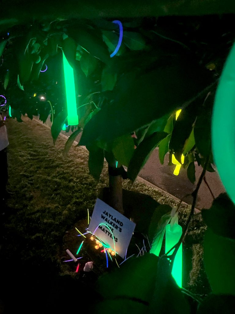 Glow sticks hang in a tree at a memorial for Jayland Walker in Akron, Ohio, on July 8, 2022. Walker died after being shot 46 times by Akron police officers days earlier, on June 27. (Photo by Gabriela Tumani/News21)