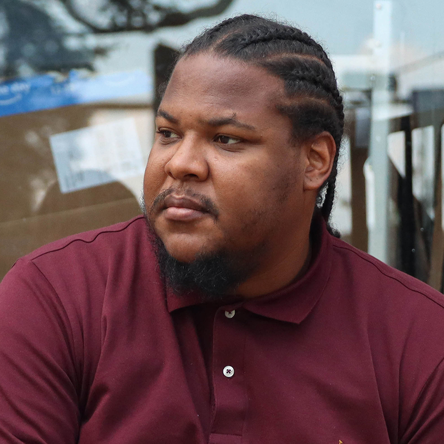 Kevin Griffin-Clark, a business owner and community member in New Orleans, LA, poses for a portrait outside his office building in St. Bernard neighborhood on July 12, 2022. Griffin-Clark is a born and raised New Orleanian who grew up in public housing and the juvenile justice system, now an activist in his community. (Photo by Kate Heston/News21)