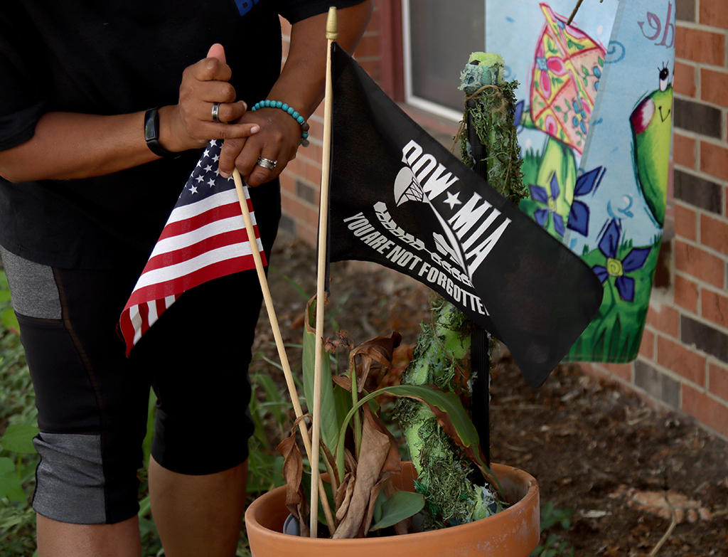 Whitney Smith McIntosh adjusts the flags in a flower pot at her home in Altoona, Iowa. “I was getting really sick of police officers being blamed for people being stupid,” says Smith McIntosh, co-founder of America Backs the Blue: Iowa. (Photo by Sarah Emily Baum/News21)