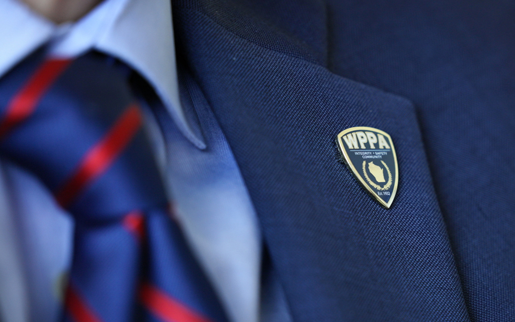 Jim Palmer, the executive director for the Wisconsin Professional Police Association, wears a WPPA pin on his jacket while at work. (Photo by Tirzah Christopher/News21)